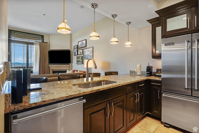 2100 W Frostwood Blvd Unit 5164, Park City, UT 84098 - kitchen featuring stainless steel appliances, light stone counters, glass insert cabinets, dark brown cabinets, and hanging light fixtures