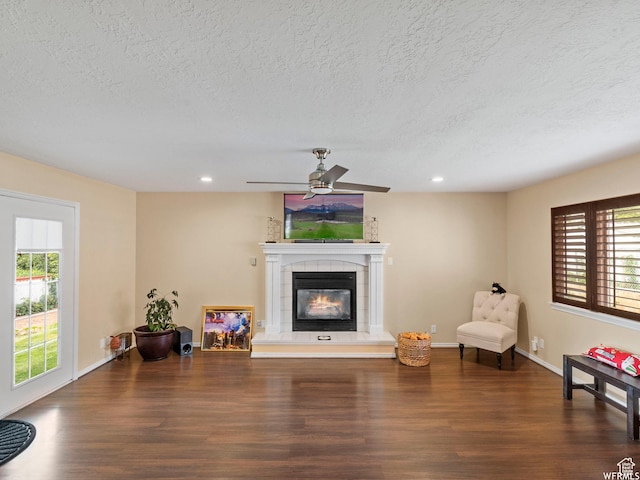 1034 E 1st St S, Ogden, UT 84404 - living area featuring wood finished floors, a textured ceiling, a tile fireplace, ceiling fan, and recessed lighting