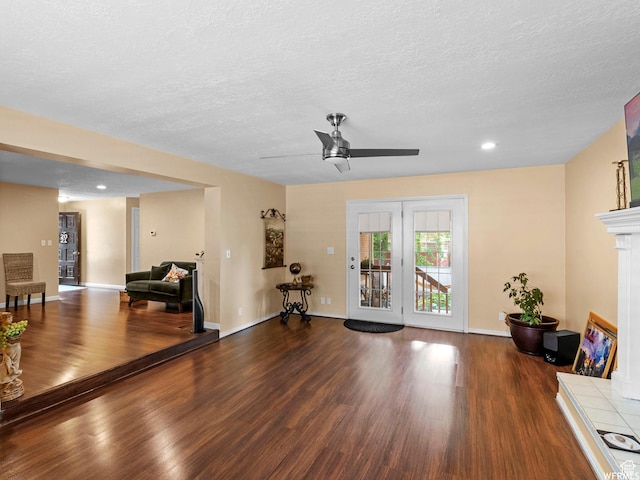 1034 E 1st St S, Ogden, UT 84404 - living room featuring wood finished floors, a ceiling fan, a textured ceiling, recessed lighting, and a fireplace