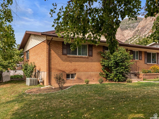 1034 E 1st St S, Ogden, UT 84404 - view of property exterior with a yard, brick siding, and a mountain view