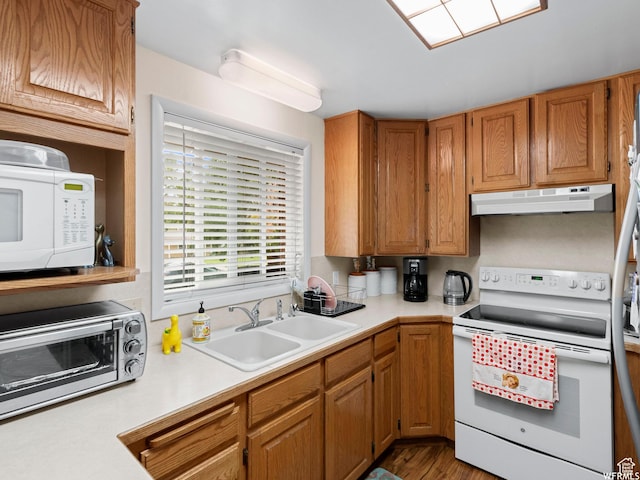 1034 E 1st St S, Ogden, UT 84404 - kitchen featuring white appliances, under cabinet range hood, light countertops, and brown cabinetry