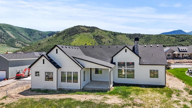 177 E 475 S, Mantua, UT 84324 - rear view of property featuring a mountain view, a chimney, roof with shingles, and a patio area
