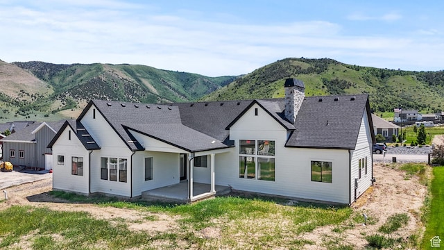 177 E 475 S, Mantua, UT 84324 - back of house with a chimney, a mountain view, roof with shingles, and a patio area