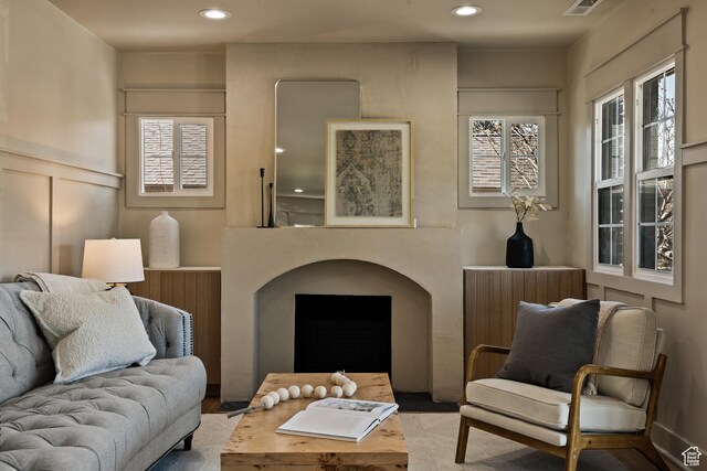 1444 E Sherman Ave, Salt Lake City, UT 84105 - living room featuring recessed lighting, a decorative wall, and wood finished floors