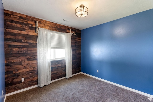145 Teal Loop, Logan, UT 84321 - carpeted empty room with wood walls and baseboards