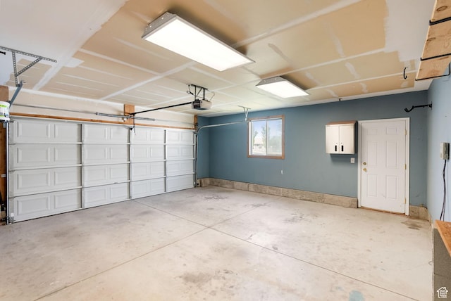 145 Teal Loop, Logan, UT 84321 - garage featuring a garage door opener and baseboards