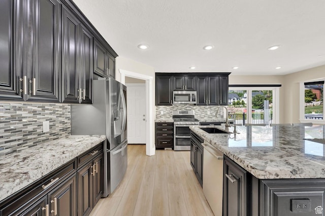 1788 N 925 E, North Ogden, UT 84414 - kitchen with stainless steel appliances, decorative backsplash, light wood-style flooring, light stone countertops, and recessed lighting