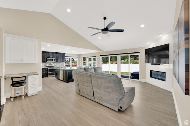 1788 N 925 E, North Ogden, UT 84414 - living room featuring a fireplace, a ceiling fan, high vaulted ceiling, light wood-type flooring, and recessed lighting