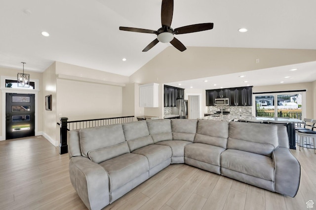 1788 N 925 E, North Ogden, UT 84414 - living area with light wood finished floors, ceiling fan, recessed lighting, and high vaulted ceiling