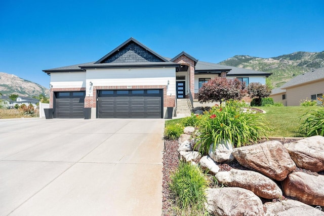 1788 N 925 E, North Ogden, UT 84414 - view of front of house featuring an attached garage, a mountain view, brick siding, driveway, and a front yard