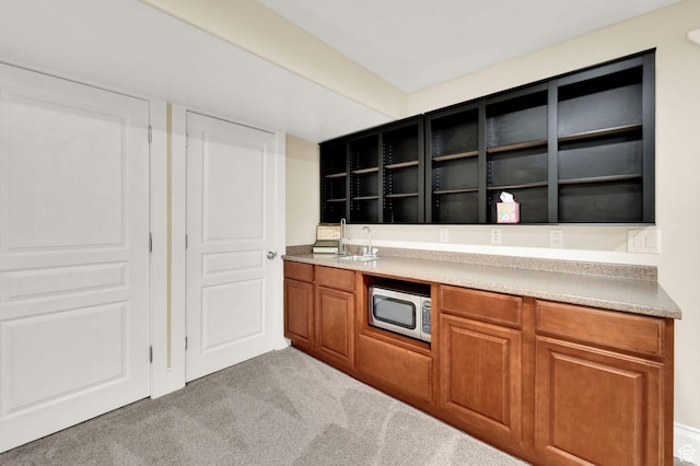 1788 N 925 E, North Ogden, UT 84414 - kitchen with stainless steel microwave, carpet flooring, open shelves, brown cabinets, and light countertops