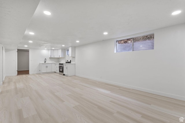 5600 S Ralph Dr, Taylorsville, UT 84129 - unfurnished living room featuring recessed lighting and light wood-style flooring