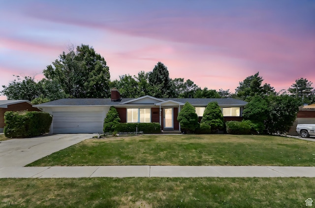 5600 S Ralph Dr, Taylorsville, UT 84129 - ranch-style house featuring an attached garage, concrete driveway, a front yard, and a chimney