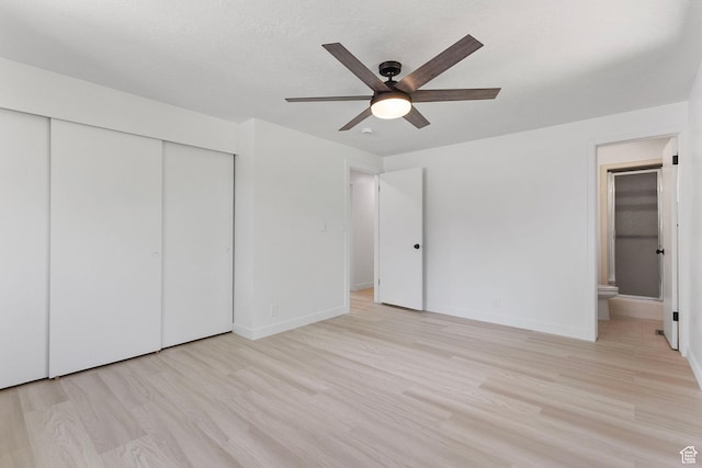 5600 S Ralph Dr, Taylorsville, UT 84129 - unfurnished bedroom featuring a closet, connected bathroom, light wood finished floors, and ceiling fan