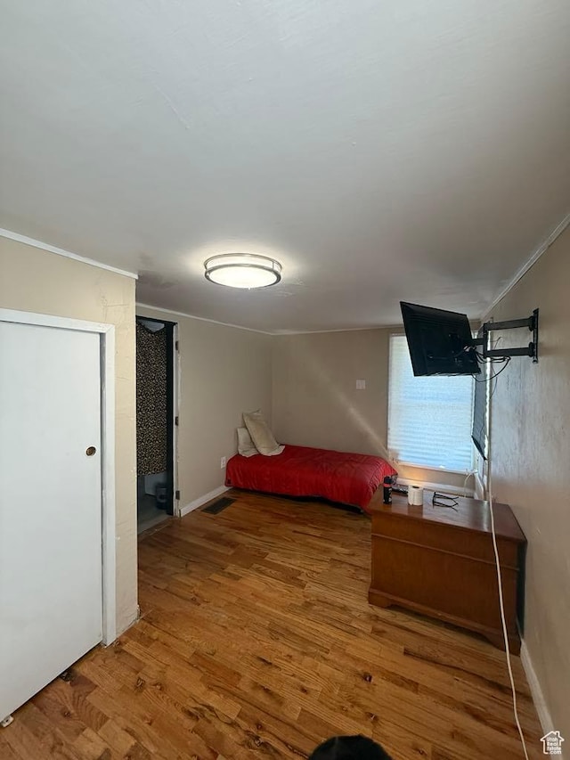 365 Hill St, Helper, UT 84526 - bedroom featuring wood finished floors and ornamental molding