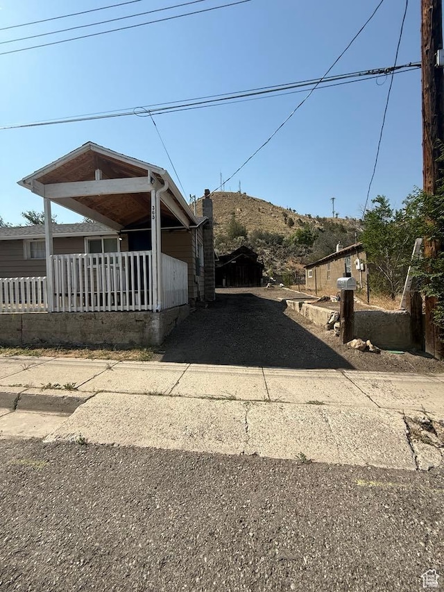 365 Hill St, Helper, UT 84526 - view of property exterior with driveway, a porch, and a chimney