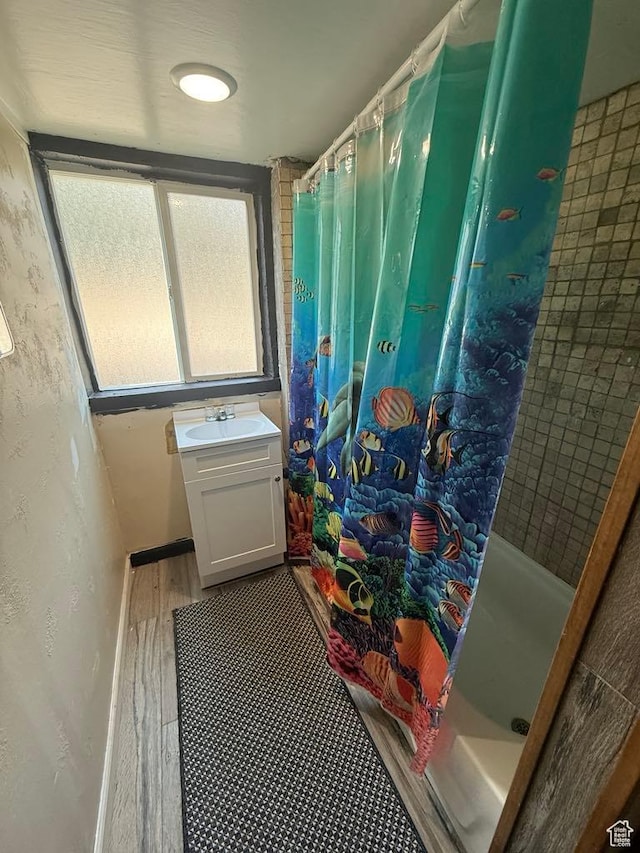 365 Hill St, Helper, UT 84526 - bathroom with curtained shower, wood finished floors, and vanity