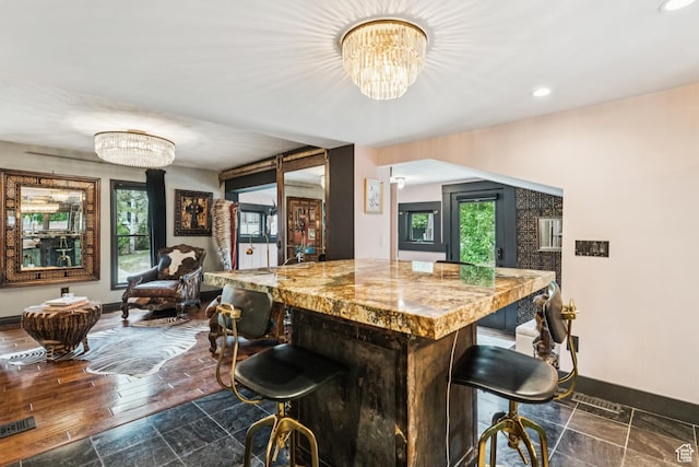 1439 Woodside Ave, Park City, UT 84060 - bar featuring healthy amount of natural light, recessed lighting, dark stone finish flooring, and a chandelier
