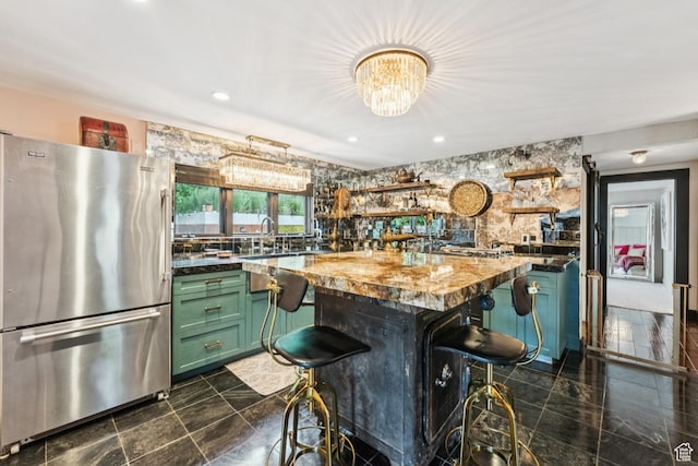 1439 Woodside Ave, Park City, UT 84060 - kitchen with freestanding refrigerator, green cabinetry, open shelves, a chandelier, and a breakfast bar