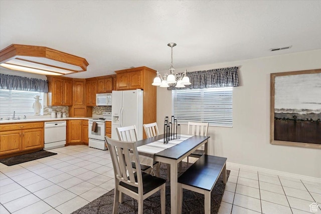 7258 S Mel Helen Way, West Jordan, UT 84084 - dining area with light tile patterned flooring and a chandelier