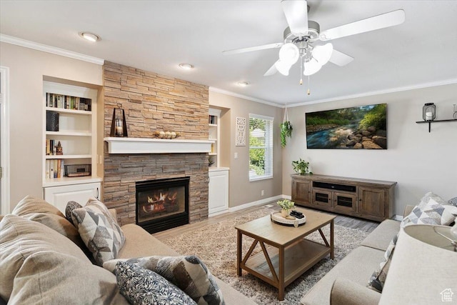 7258 S Mel Helen Way, West Jordan, UT 84084 - living area with crown molding, wood finished floors, a stone fireplace, ceiling fan, and built in shelves