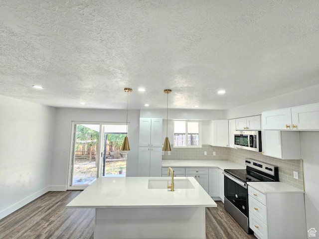 3797 S Armoridge Dr, Magna, UT 84044 - kitchen with stainless steel appliances, dark wood-style flooring, healthy amount of natural light, a textured ceiling, and recessed lighting