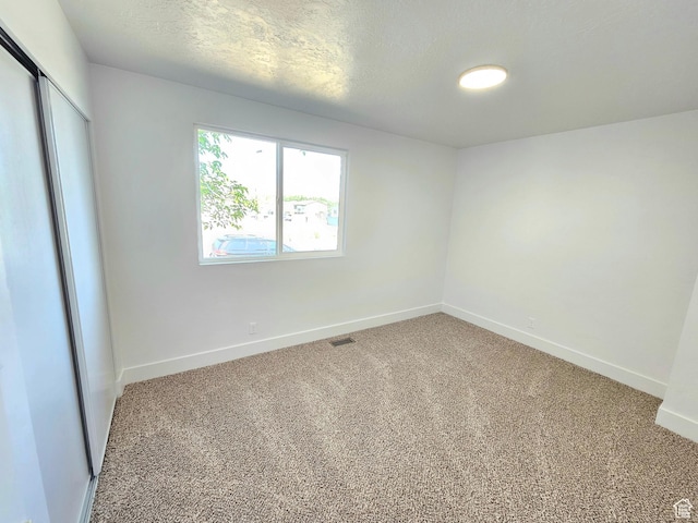 3797 S Armoridge Dr, Magna, UT 84044 - unfurnished bedroom featuring light carpet, a closet, and a textured ceiling