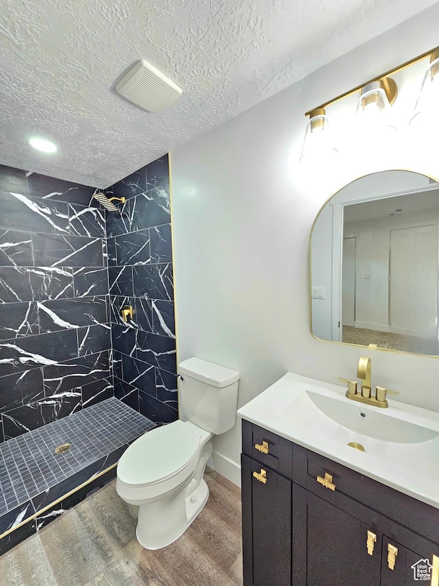 3797 S Armoridge Dr, Magna, UT 84044 - full bathroom featuring vanity, a shower stall, wood finished floors, and a textured ceiling