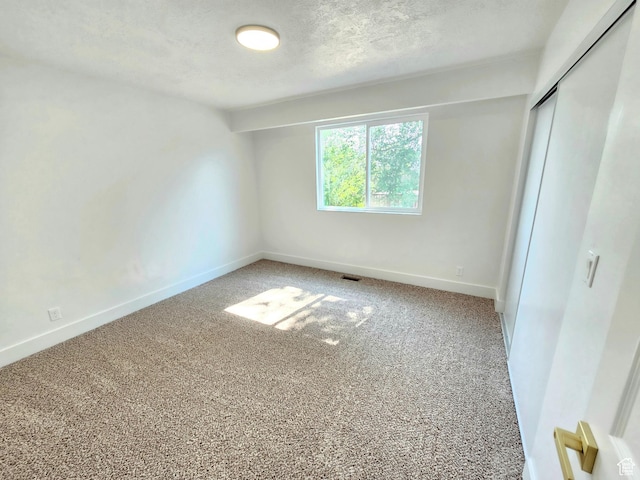 3797 S Armoridge Dr, Magna, UT 84044 - unfurnished bedroom featuring light colored carpet, a textured ceiling, and a closet
