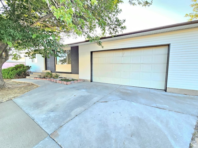 3797 S Armoridge Dr, Magna, UT 84044 - view of front of property featuring driveway, a garage, and brick siding