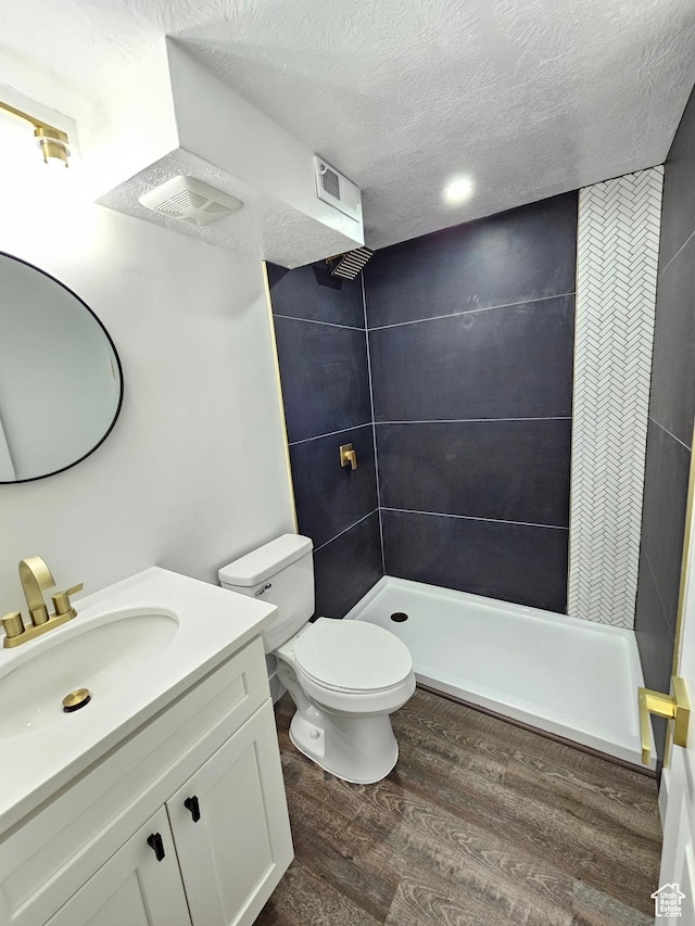3797 S Armoridge Dr, Magna, UT 84044 - bathroom with a shower stall, wood finished floors, vanity, and a textured ceiling