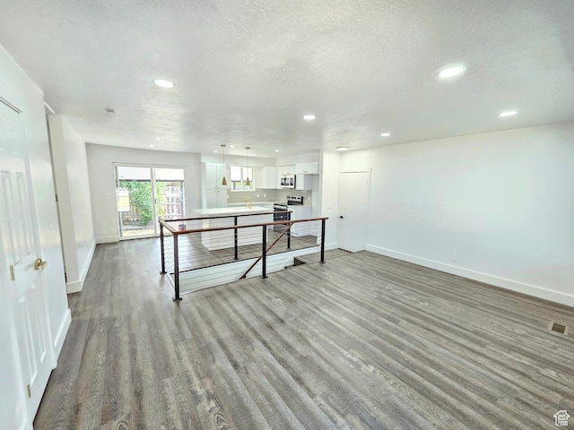 3797 S Armoridge Dr, Magna, UT 84044 - interior space with recessed lighting, wood finished floors, and a textured ceiling