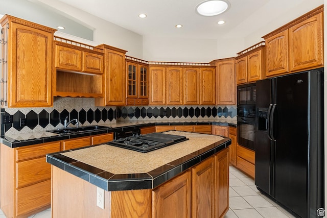 831 N Brookside Dr, Preston, ID 83263 - kitchen with black appliances, a center island, light tile patterned floors, brown cabinetry, and recessed lighting