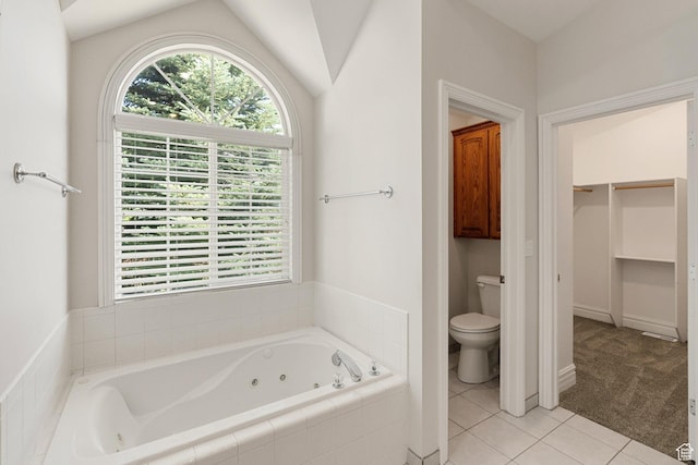 831 N Brookside Dr, Preston, ID 83263 - bathroom featuring a whirlpool tub, tile patterned floors, vaulted ceiling, and a walk in closet