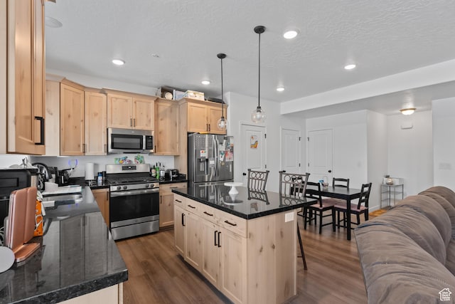 4211 W Camp Floyd Ct, Riverton, UT 84096 - kitchen with stainless steel appliances, light brown cabinetry, dark wood-style floors, a kitchen bar, and recessed lighting