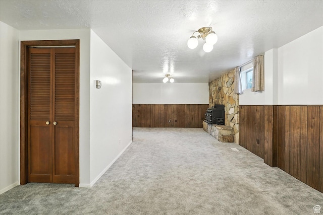 434 River Heights Blvd, River Heights, UT 84321 - unfurnished living room featuring wood walls, carpet floors, wainscoting, and a textured ceiling