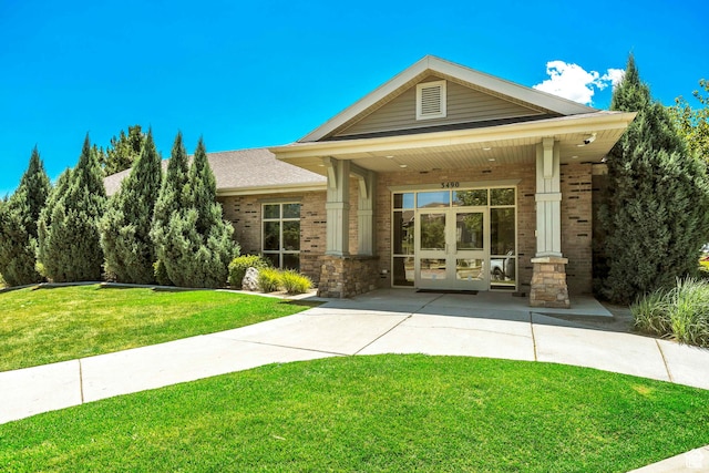 8176 N Cedar Springs Rd Unit V3, Eagle Mountain, UT 84005 - view of front of property with brick siding, french doors, and a front yard