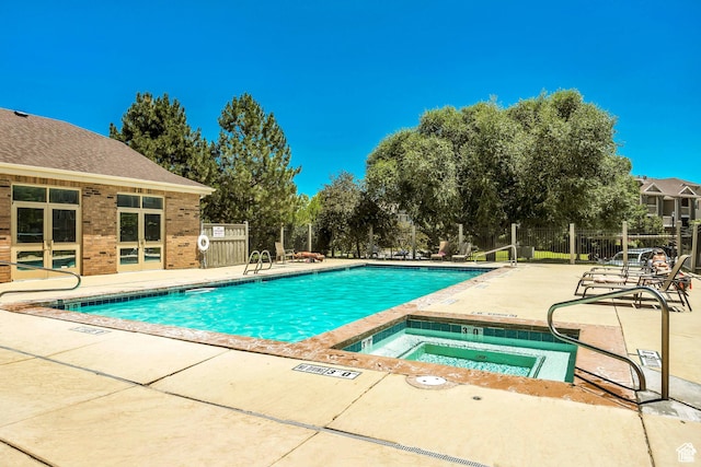 8176 N Cedar Springs Rd Unit V3, Eagle Mountain, UT 84005 - community pool with a community hot tub, a patio area, and view of scattered trees