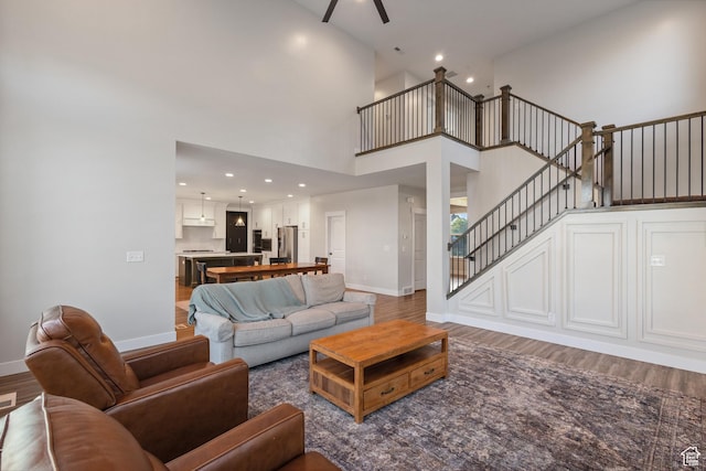 1401 W 1930 N, Pleasant Grove, UT 84062 - living area featuring stairway, wood finished floors, a towering ceiling, recessed lighting, and a ceiling fan