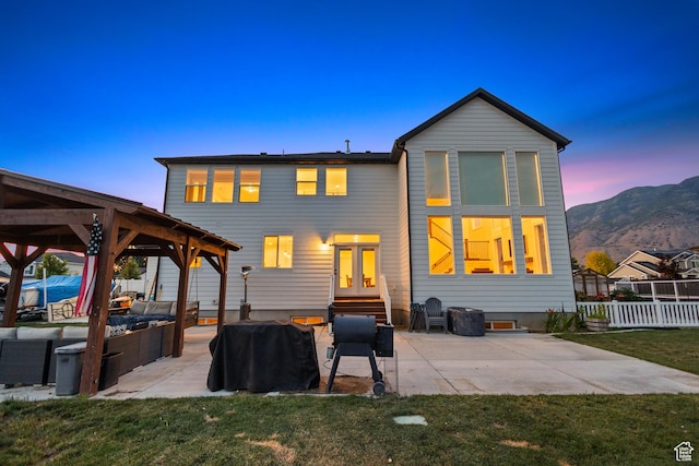 1401 W 1930 N, Pleasant Grove, UT 84062 - back of property at dusk featuring a patio, a gazebo, an outdoor hangout area, a mountain view, and entry steps