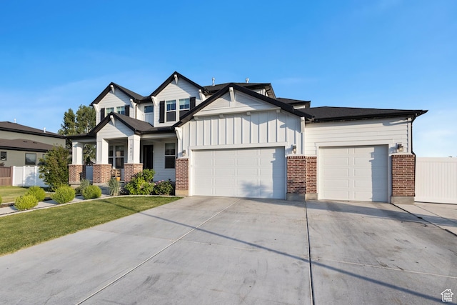 1401 W 1930 N, Pleasant Grove, UT 84062 - view of front of house featuring an attached garage, brick siding, concrete driveway, and board and batten siding