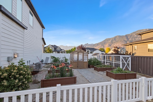 1401 W 1930 N, Pleasant Grove, UT 84062 - fenced backyard featuring a vegetable garden, a storage unit, a mountain view, and a residential view