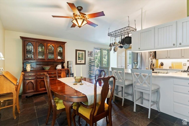 4420 Parkview Dr, Ogden, UT 84403 - dining room with a ceiling fan and dark stone finish flooring