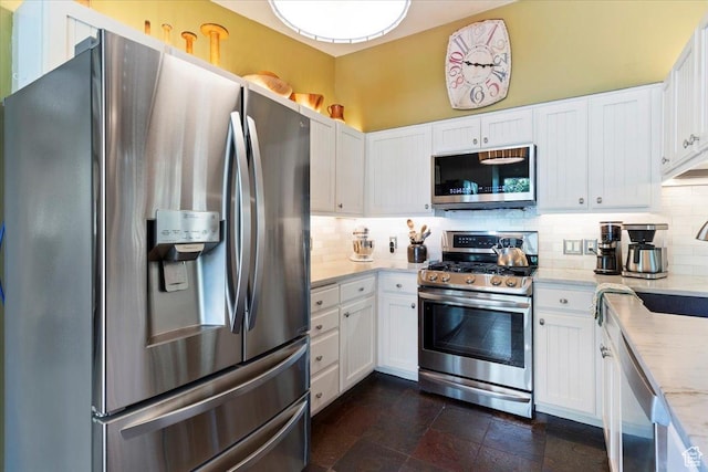 4420 Parkview Dr, Ogden, UT 84403 - kitchen with stainless steel appliances, tasteful backsplash, white cabinetry, and dark stone finish flooring