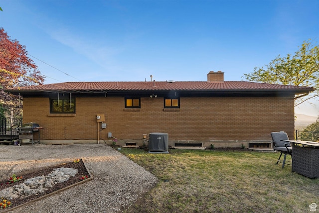 3327 S Crestwood Dr, Salt Lake City, UT 84109 - back of property featuring a chimney, a yard, and brick siding