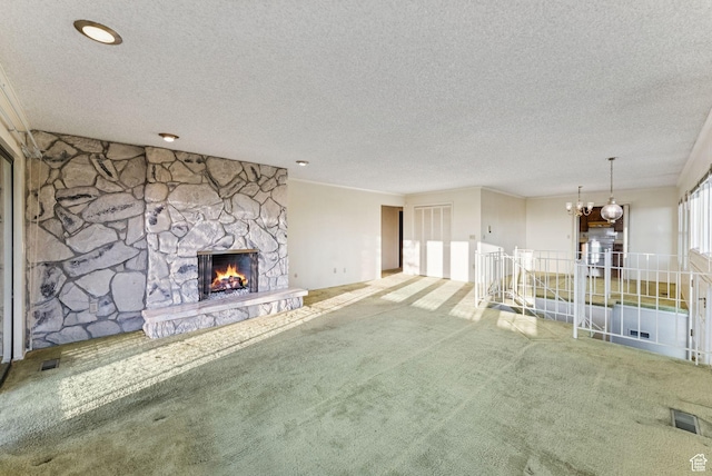 3327 S Crestwood Dr, Salt Lake City, UT 84109 - unfurnished living room with carpet flooring, a chandelier, a stone fireplace, and a textured ceiling