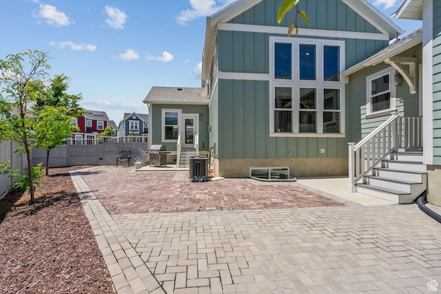11571 S Skyward Rd W, South Jordan, UT 84009 - rear view of property with board and batten siding and a patio