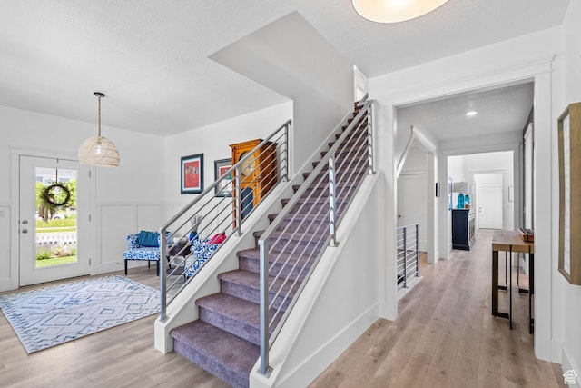 11571 S Skyward Rd W, South Jordan, UT 84009 - entryway featuring light wood-style flooring, stairway, and a textured ceiling