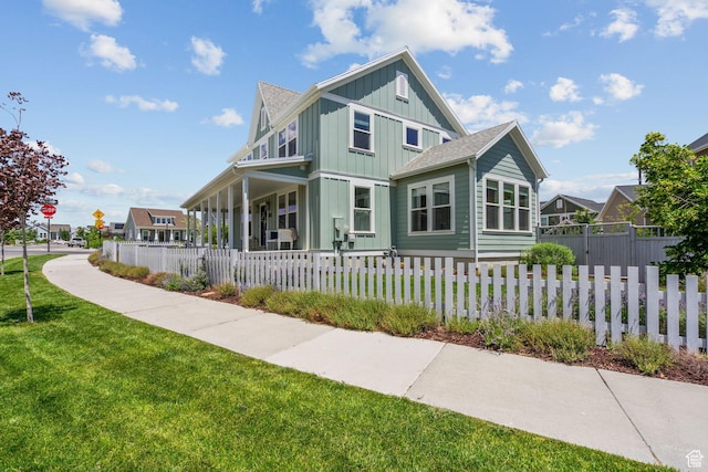 11571 S Skyward Rd W, South Jordan, UT 84009 - view of front of house with board and batten siding, a porch, a fenced front yard, and roof with shingles