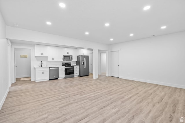 11571 S Skyward Rd W, South Jordan, UT 84009 - kitchen featuring appliances with stainless steel finishes, white cabinetry, light wood finished floors, recessed lighting, and light countertops